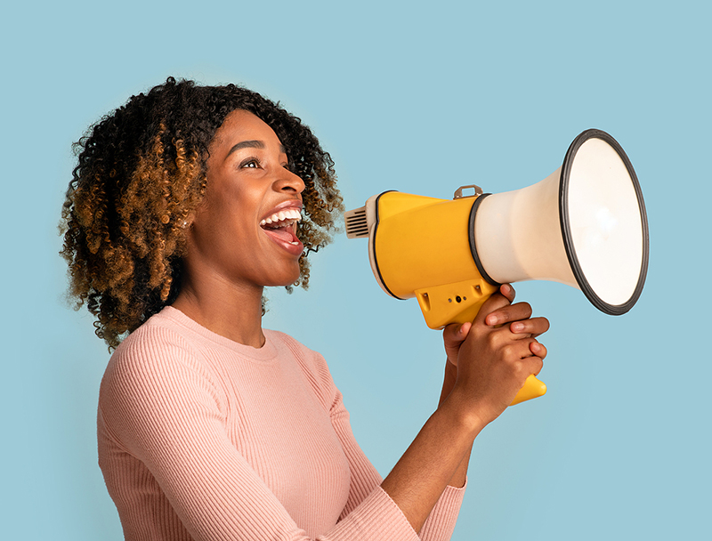 Announcement Concept. Cheerful Black Woman Shouting With Megaphone In Hands, Blue Background