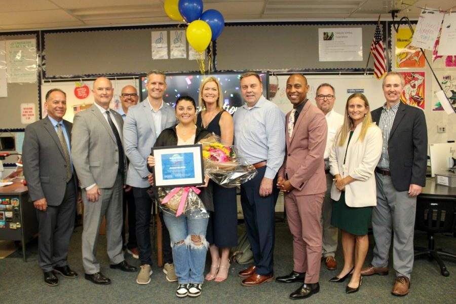 Teacher Jillian Nelson surrounded by administrators and guests after receiving the Ripple Effect Teacher Award
